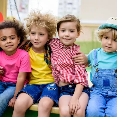 adorable-curly-boy-embracing-two-multicultural